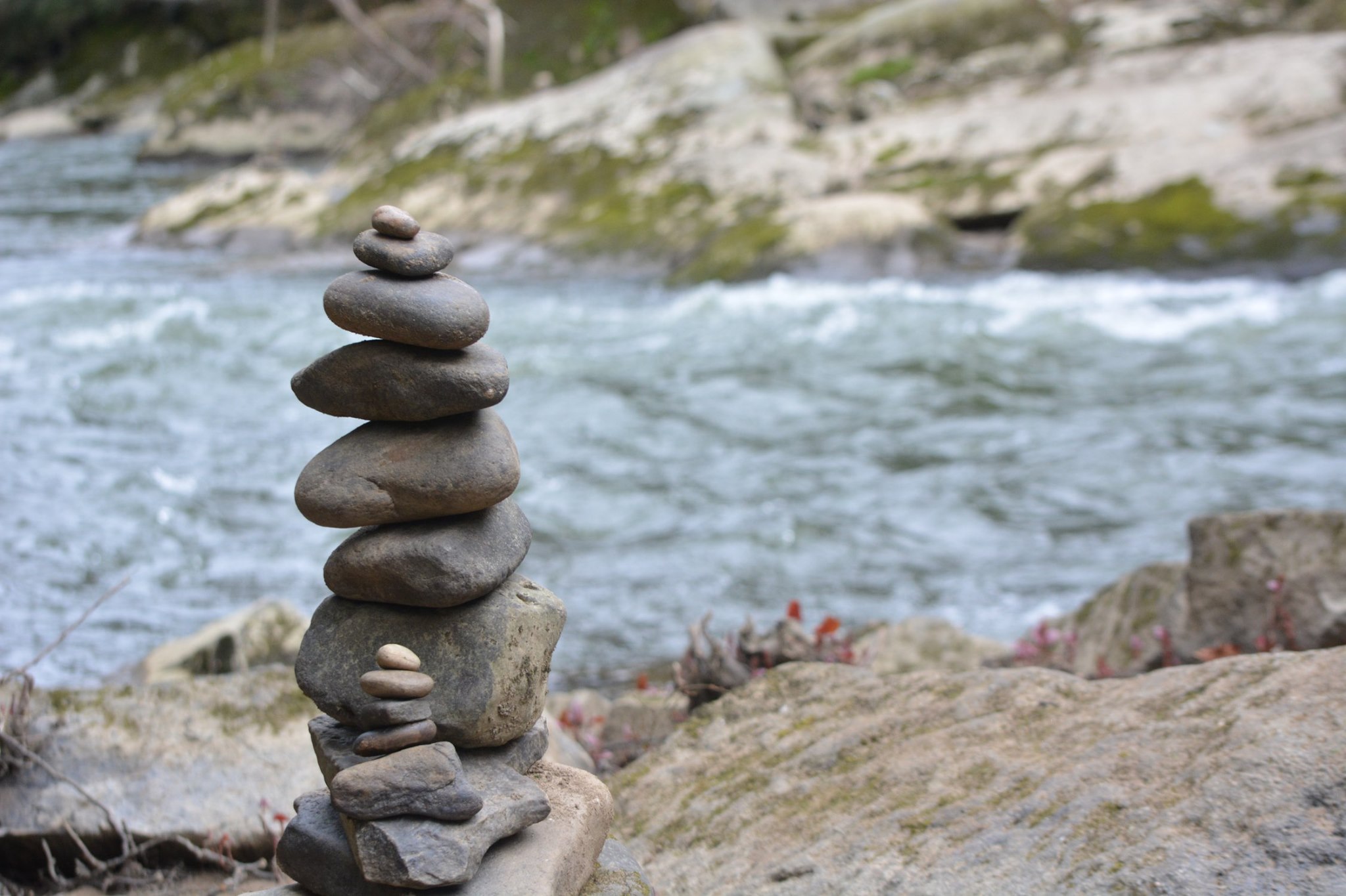 Stones stacked by a river