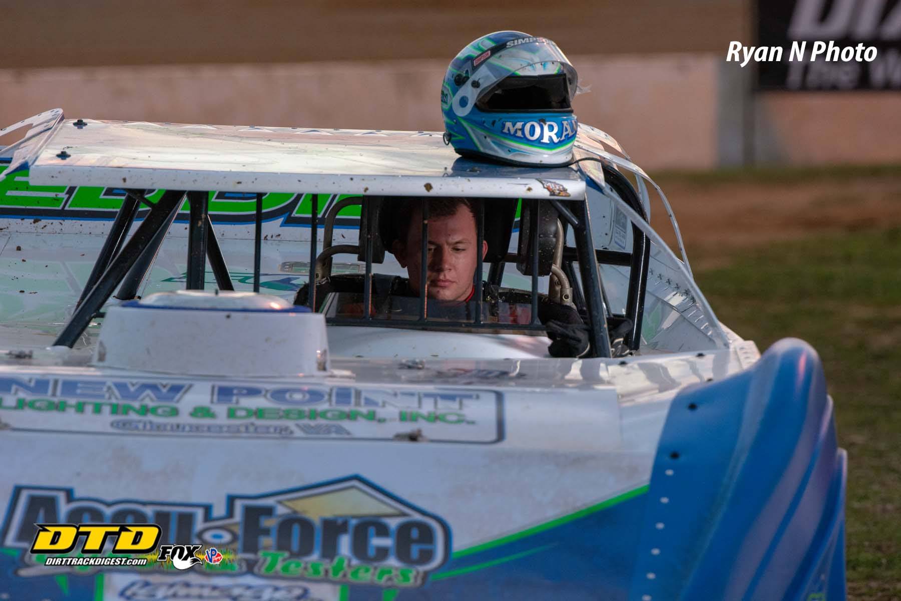 Driver Devin Moran sitting in his car in his pit area